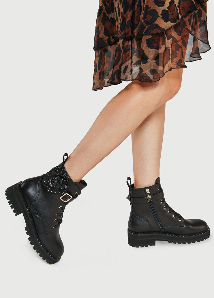 Leather combat boots with studded flowers