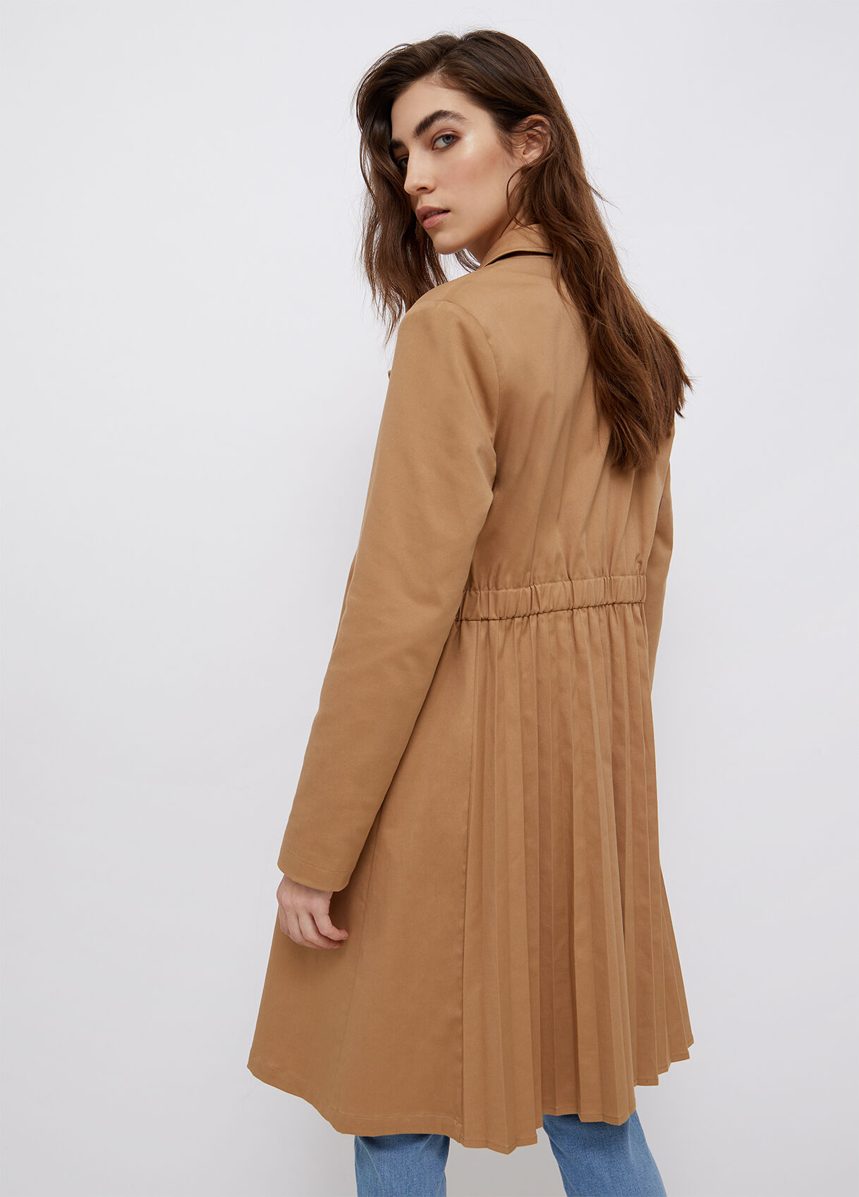 Trench coat with pleats on the back