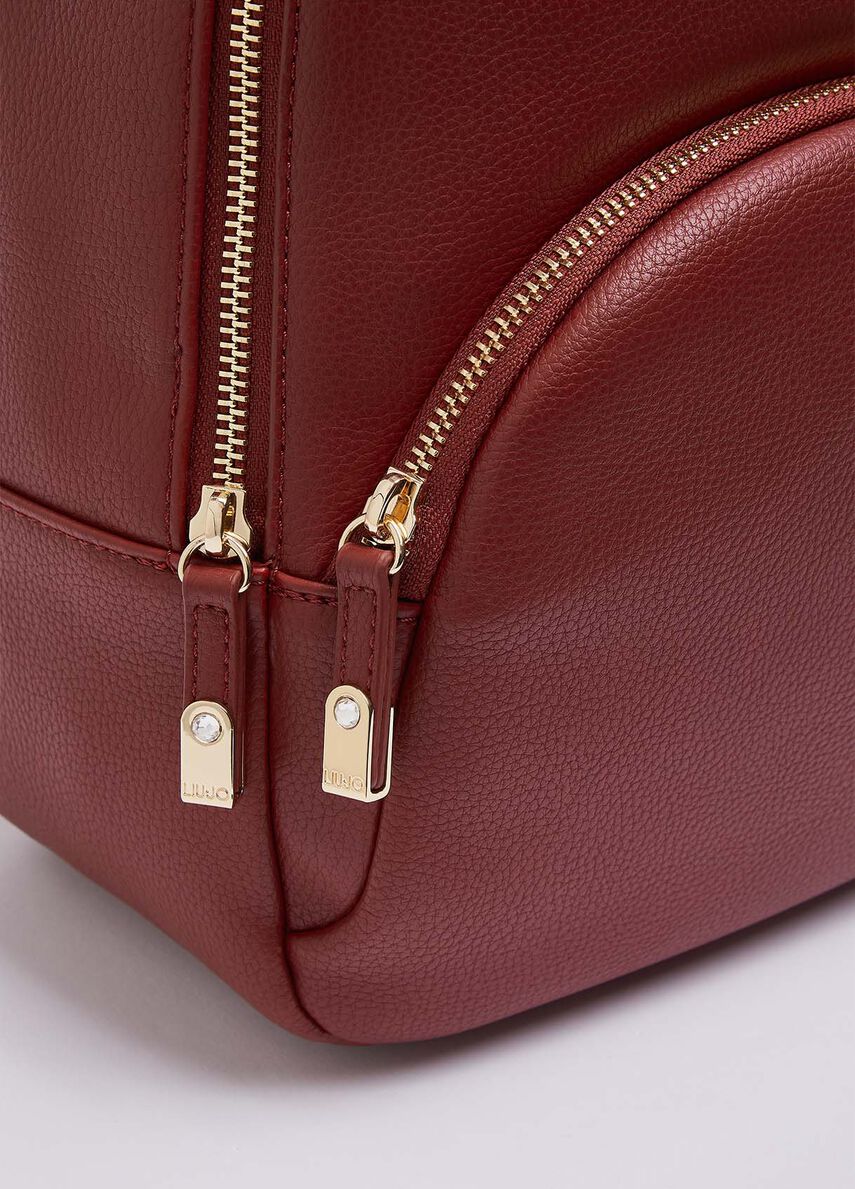 festival mini backpack crushed berry pebble Grain Small Murphy Back exterior has a slim strap to secure onto a rolling case festival mini backpack crushed berry